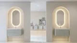 Tyylikäs ja moderni kylpyhuone inspiraatio, jossa on soikeat peilit valonsäädöllä, kivialtaat ja uurteiset pesuallaskaapit minimalistisessa suunnittelussa, valoisa ja ilmava tunnelma, elegantti valaistus ja hienostuneet yksityiskohdat